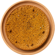 Round, crispy chat masala khakhra on a wooden plate.