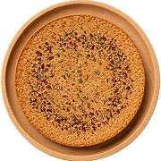 Round Indian khakhra snack sprinkled with spices on a wooden plate.